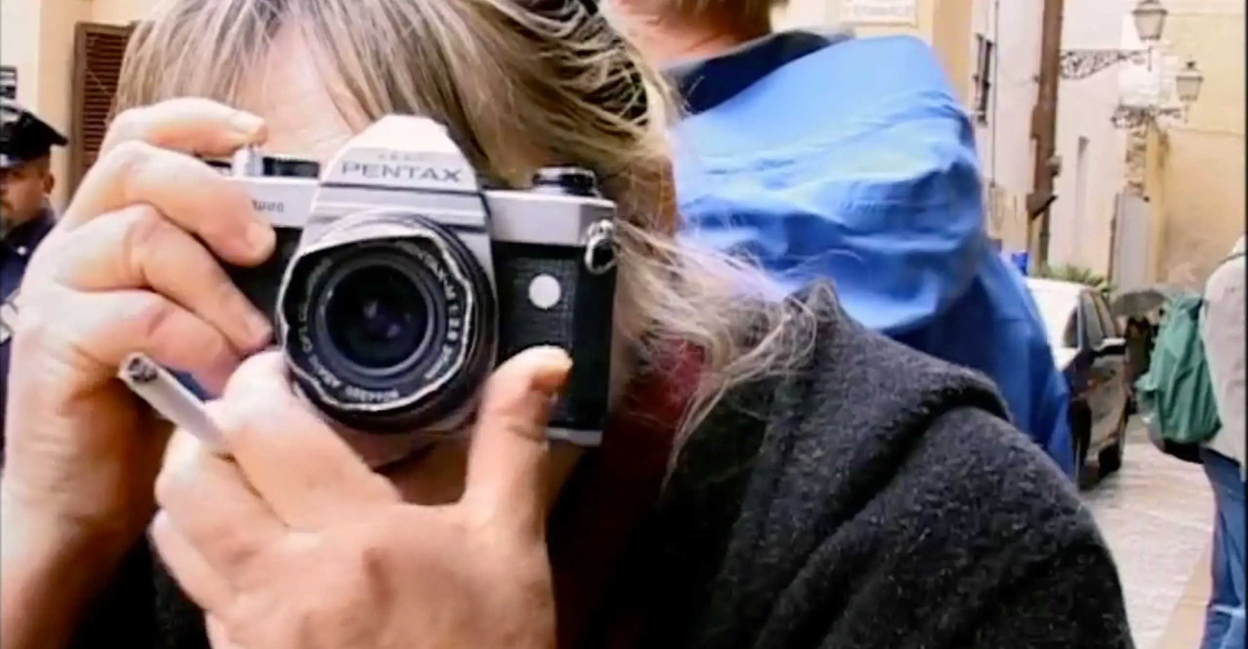 Portrait of Letizia Battaglia with camera in-hand, with camera obscuring face